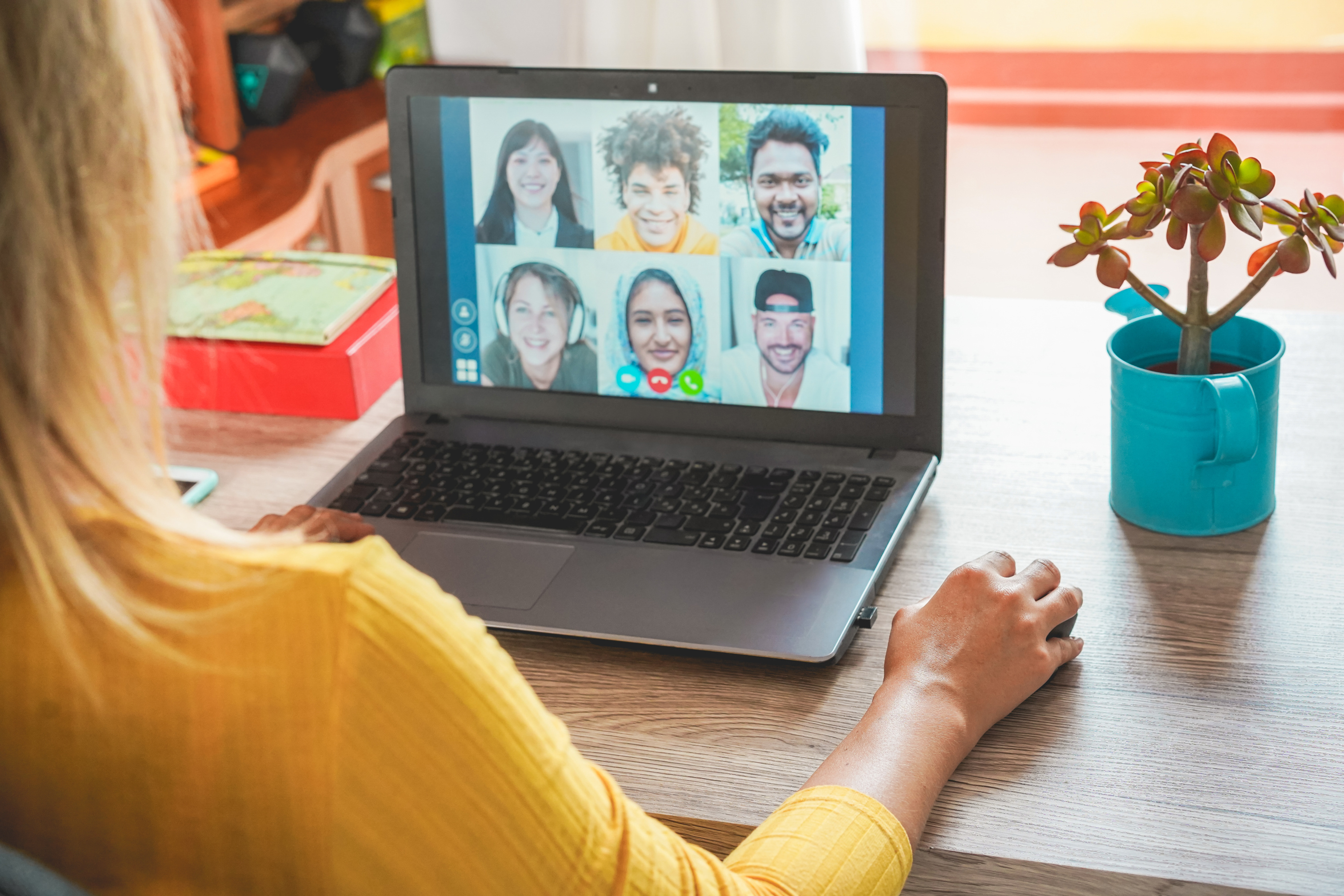 Woman Socialising With Colleagues Via Video Call On Laptop